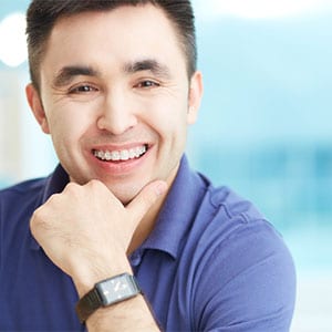 adult asian man with braces smiling