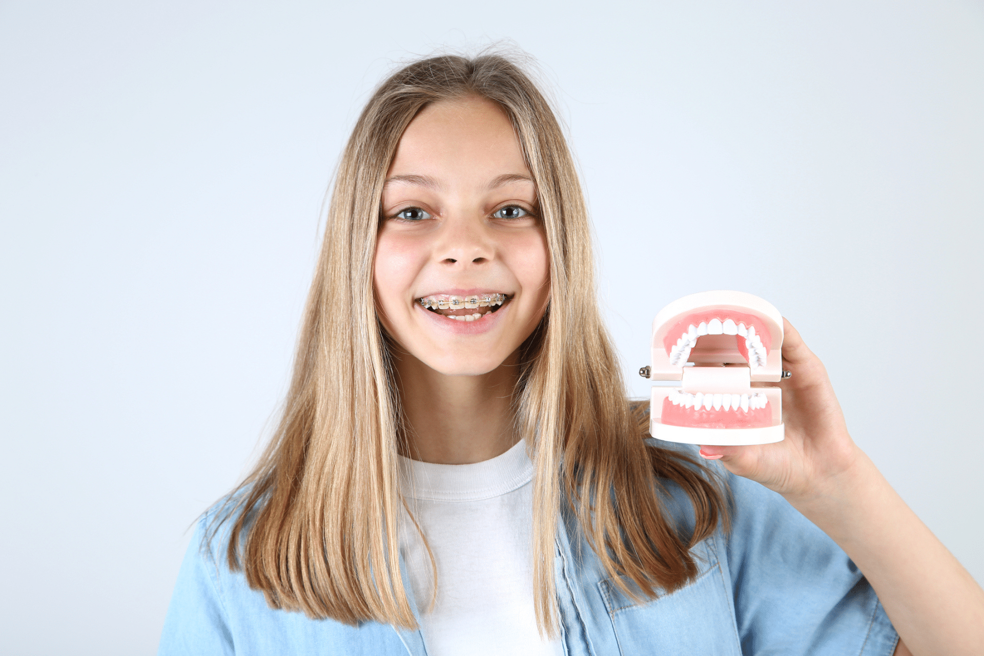 Teen smiling with braces during orthodontic treatment in Lacey, WA