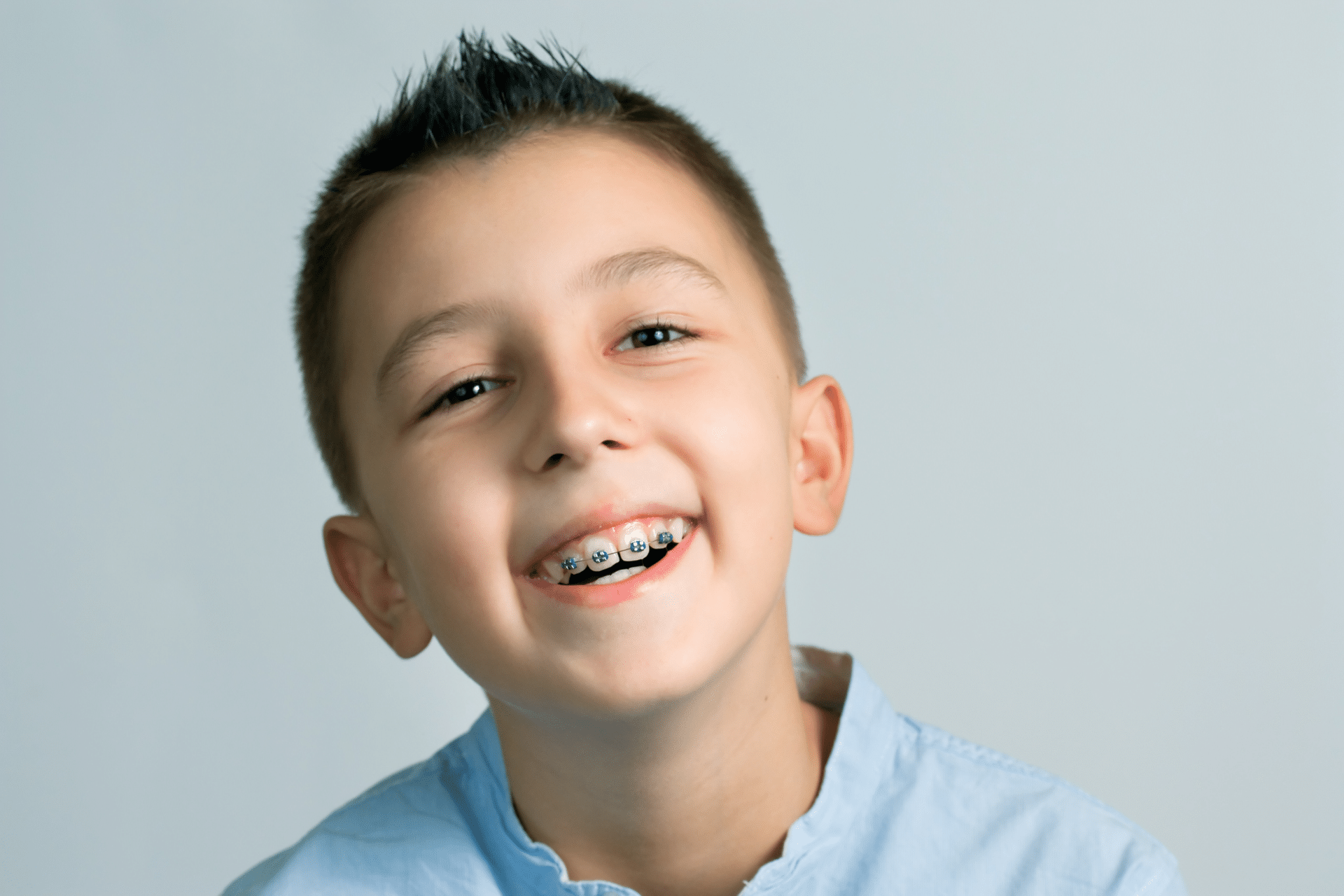 Child smiling with braces for summer orthodontic care in Lacey WA